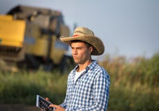 Farmer with combine harvester in field Stock Photo Farmer with combine harvester in field Stock Photo