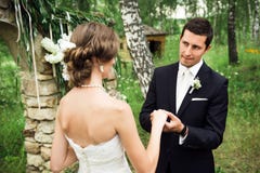 Handsome groom is fixing a wedding ring royalty free stock photography Handsome groom is fixing a wedding ring royalty free stock photography