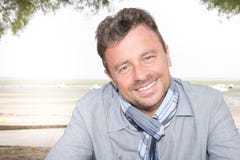 Handsome man with blue eyes sit outdoor stock photography Handsome man with blue eyes sit outdoor stock photography