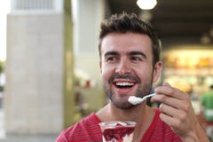 Handsome man eating a yummy ice cream Stock Photography Handsome man eating a yummy ice cream Stock Photography