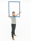 Handsome man holding a wooden frame Royalty Free Stock Images Handsome man holding a wooden frame Royalty Free Stock Images