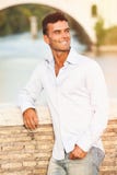 Handsome man Italian outdoors in Rome Italy. Tiber river and bridge stock photo Handsome man Italian outdoors in Rome Italy. Tiber river and bridge stock photo