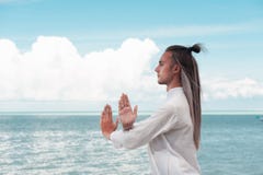 Handsome man is practicing Taijiquan on the beach royalty free stock photos Handsome man is practicing Taijiquan on the beach royalty free stock photos