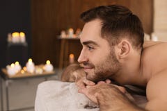 Handsome man relaxing on massage table in spa salon royalty free stock photo Handsome man relaxing on massage table in spa salon royalty free stock photo