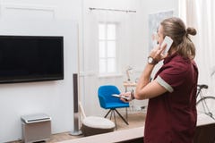 handsome man with remote control talking on smartphone and watching tv royalty free stock photos handsome man with remote control talking on smartphone and watching tv royalty free stock photos