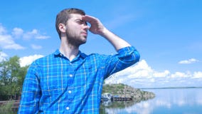 Handsome man of the ship and looking to the city.Man ,stylish boy,blue shirt,pretty boy,attractive,spring vacations stock photos Handsome man of the ship and looking to the city.Man ,stylish boy,blue shirt,pretty boy,attractive,spring vacations stock photos