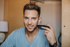 Handsome man using mobile smartphone for surfing web internet and sending audio message. Man using gadget at modern royalty free stock photos Handsome man using mobile smartphone for surfing web internet and sending audio message. Man using gadget at modern royalty free stock photos