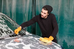 A handsome man is washing a car Stock Photo A handsome man is washing a car Stock Photo