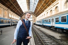 Mature businessman on a train station. Royalty Free Stock Photography Mature businessman on a train station. Royalty Free Stock Photography