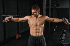 Handsome power athletic man bodybuilder doing exercises with dumbbell royalty free stock photo Handsome power athletic man bodybuilder doing exercises with dumbbell royalty free stock photo
