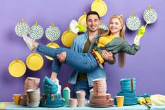 Handsome smiling man holding his girlfriend in hands and looking at the camera royalty free stock images Handsome smiling man holding his girlfriend in hands and looking at the camera royalty free stock images