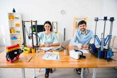 Handsome smiling students using 3d printer Stock Photography Handsome smiling students using 3d printer Stock Photography