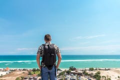 Handsome traveler man stay by blue ocean background - Happy guy relaxing at sea view point - Concept of freedom and stock photos Handsome traveler man stay by blue ocean background - Happy guy relaxing at sea view point - Concept of freedom and stock photos