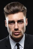Handsome young man in suit on dark background stock photography Handsome young man in suit on dark background stock photography