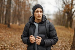 Handsome young man in winter clothes with a backpack Royalty Free Stock Photography Handsome young man in winter clothes with a backpack Royalty Free Stock Photography