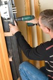 Handyman repairing lock