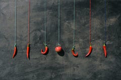 Hanging on colorful strings many red hot chili peppers and apple royalty free stock photo Hanging on colorful strings many red hot chili peppers and apple royalty free stock photo