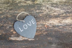 Hanging heart and wooden background in country style. Royalty Free Stock Image Hanging heart and wooden background in country style. Royalty Free Stock Image