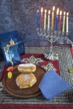 Hanukkah Menorah with lit Candles, Gifts, Dreidel and Jelly Fill royalty free stock photos Hanukkah Menorah with lit Candles, Gifts, Dreidel and Jelly Fill royalty free stock photos