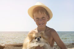 Happy 8 Year Old Boy Hugging His Dog Pomeranian Shpitz Friendship Beetwin People And Dog Stock Images
