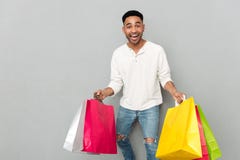 Happy african man holding shopping bags. Stock Images Happy african man holding shopping bags. Stock Images