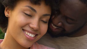 Happy afro american couple embracing and smiling, closeness, spiritual affinity stock video Happy afro american couple embracing and smiling, closeness, spiritual affinity stock video