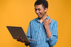 Happy Afro American teenager working with laptop. Royalty Free Stock Photos Happy Afro American teenager working with laptop. Royalty Free Stock Photos