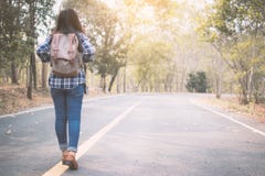 Happy Asian woman backpack in the road and forest background royalty free stock photo Happy Asian woman backpack in the road and forest background royalty free stock photo