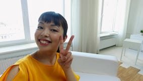 happy asian young woman taking selfie