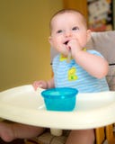 Happy baby infant boy eating meal royalty free stock photography Happy baby infant boy eating meal royalty free stock photography