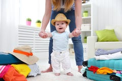 Happy baby taddler makes the first step with mother and bags to royalty free stock photo Happy baby taddler makes the first step with mother and bags to royalty free stock photo