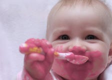 Happy Baby With A Spoon In The Mouth Royalty Free Stock Photo