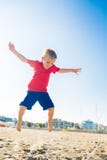 Happy Beautiful Little Boy Jump At The Sand Beach Royalty Free Stock Images