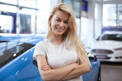 Beautiful young woman buying new car at the dealership stock images Beautiful young woman buying new car at the dealership stock images
