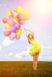 Happy birthday woman against the sky with rainbow-colored air ba Royalty Free Stock Photo Happy birthday woman against the sky with rainbow-colored air ba Royalty Free Stock Photo