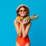 Happy black girl in swimsuit enjoying fresh summer fruits royalty free stock images Happy black girl in swimsuit enjoying fresh summer fruits royalty free stock images