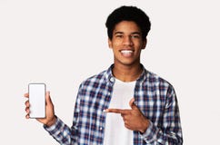Happy Black Guy Holding Smartphone With Blank Screen Royalty Free Stock Photo
