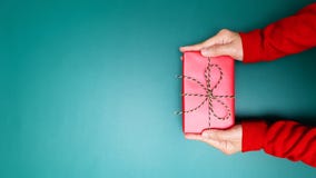 Happy Boxing Day, Young Woman Hand With A Gift Box Offer To Receiver Royalty Free Stock Image