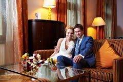 Happy Bride And Groom In Interior Of Hotel Room Stock Photo