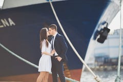 Happy bride and groom hugging near ship stock image Happy bride and groom hugging near ship stock image