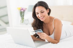 Happy brunette shopping online with laptop royalty free stock image Happy brunette shopping online with laptop royalty free stock image