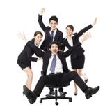 Happy Business group push colleague sitting in chair royalty free stock photo Happy Business group push colleague sitting in chair royalty free stock photo