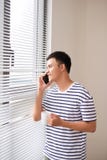 Happy business man drinking coffee and talking by the smartphone Stock Image Happy business man drinking coffee and talking by the smartphone Stock Image