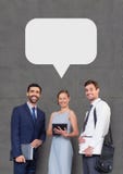 Happy business people with speech bubble holding devices against grey background royalty free stock photos Happy business people with speech bubble holding devices against grey background royalty free stock photos