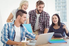 Happy business people working on laptop Stock Photography Happy business people working on laptop Stock Photography