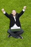 Happy Businessman On The Grass With Laptop Stock Images