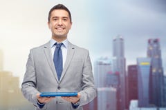 Happy businessman in suit holding tablet pc stock photos Happy businessman in suit holding tablet pc stock photos