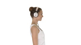 Happy casual girl wearing headphones walking on white background. stock photos Happy casual girl wearing headphones walking on white background. stock photos