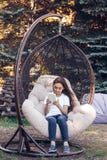 Happy caucasian girl holding white tablet PC, sitting in a park stock photos Happy caucasian girl holding white tablet PC, sitting in a park stock photos