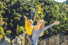 Happy cheerful joyful tourists mom and son at Great Wall of China having fun on travel smiling laughing and dancing stock photos Happy cheerful joyful tourists mom and son at Great Wall of China having fun on travel smiling laughing and dancing stock photos